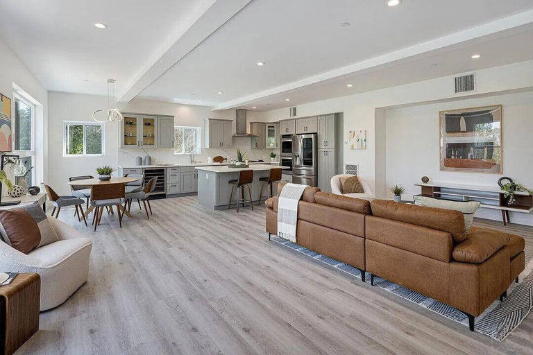 Living room with a kitchen and brown couch