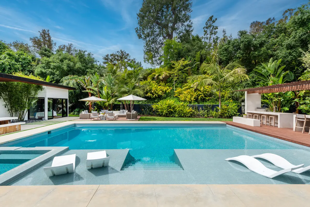 Pool and spa with lounge chairs and bar