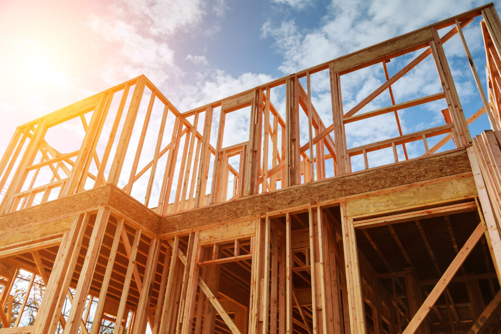 New residential construction home framing against a blue sky. Roofing construction. Wooden construction