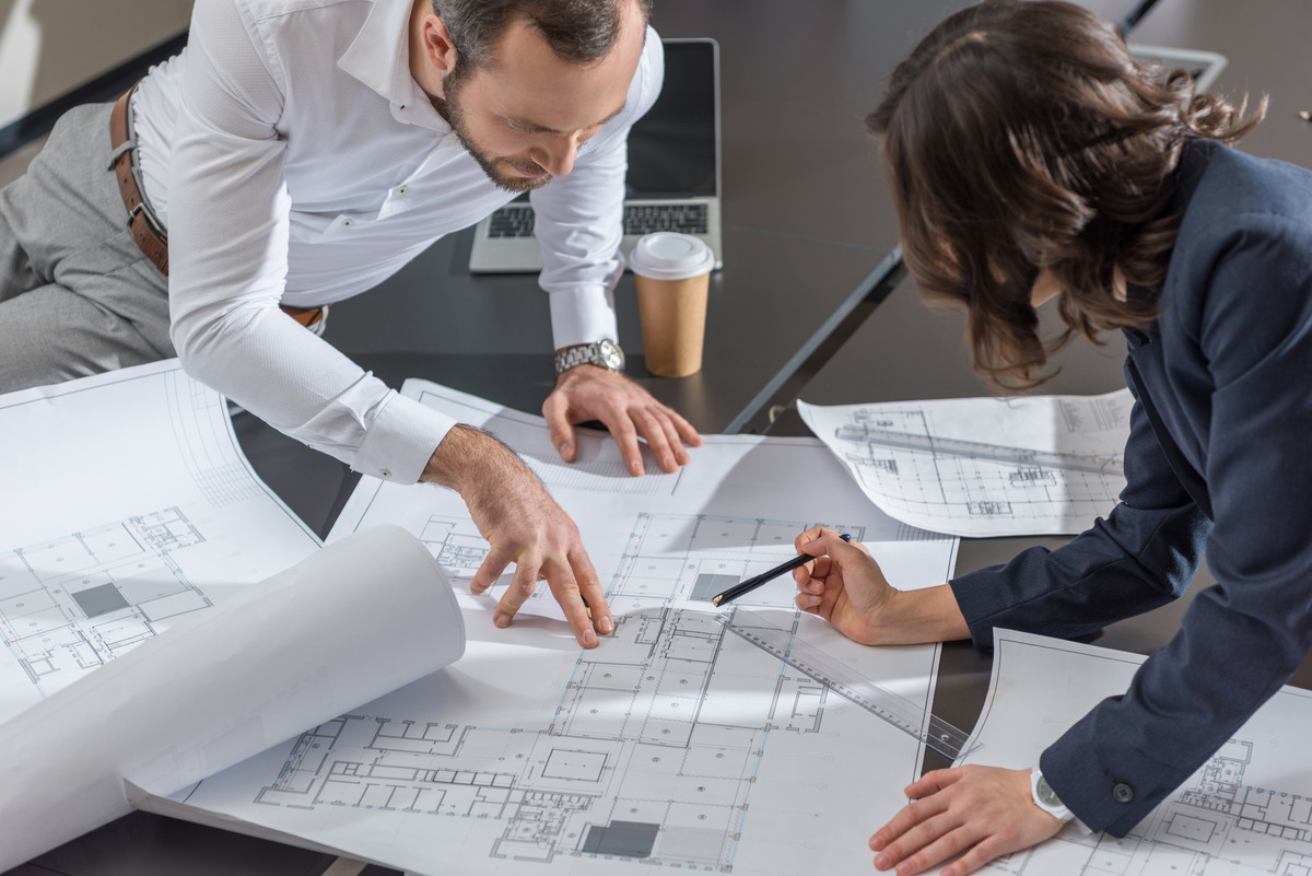 Architects reviewing building plans for a commercial building